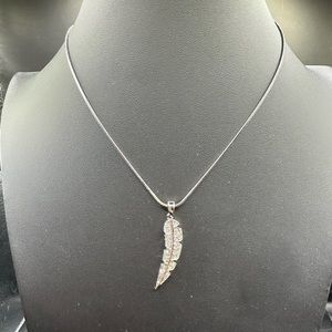 Clear crystal feather on a silver chain.